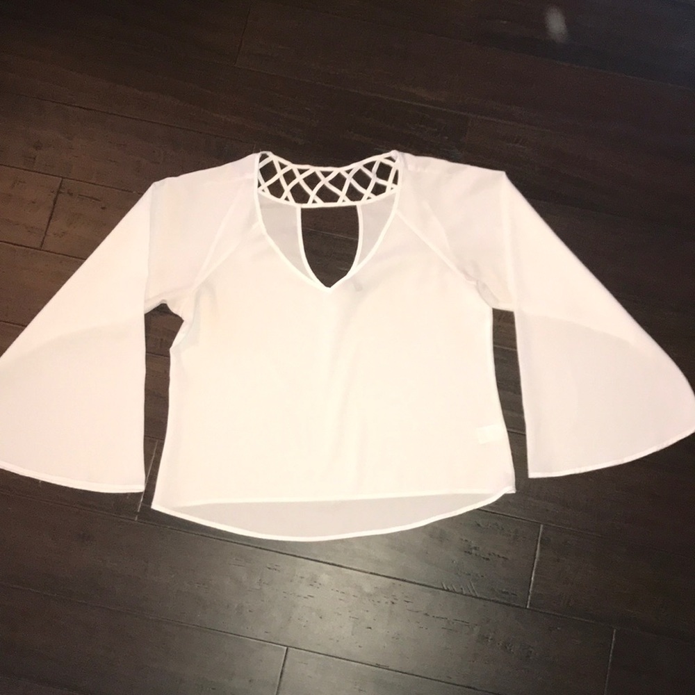 Semi sheer top with bell sleeves.